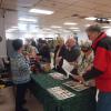 People looking at the main display of the Fredericton North Heritage Association. 