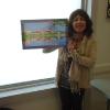 Winner of the Booker award, Jill Hargrove, with her prize, a painting by Carol Randall. 