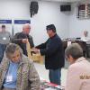  FNHA president Eric Megarity giving David Adams his door prize which was a child's adirondack chair made by George Crawford