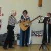 ​FNHA member Marilyn Demerchant presenting the Doucet Family Singers with a gift certificate. 