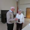At the February 2014 meeting, member Ernie MacFadzen is thanking long-time member Mary Murch who is moving to Harvey. 